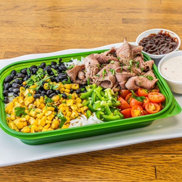 A healthy Garden of Eat'n bowl with beef, black beans, corn, peppers, tomatoes, and rice.
